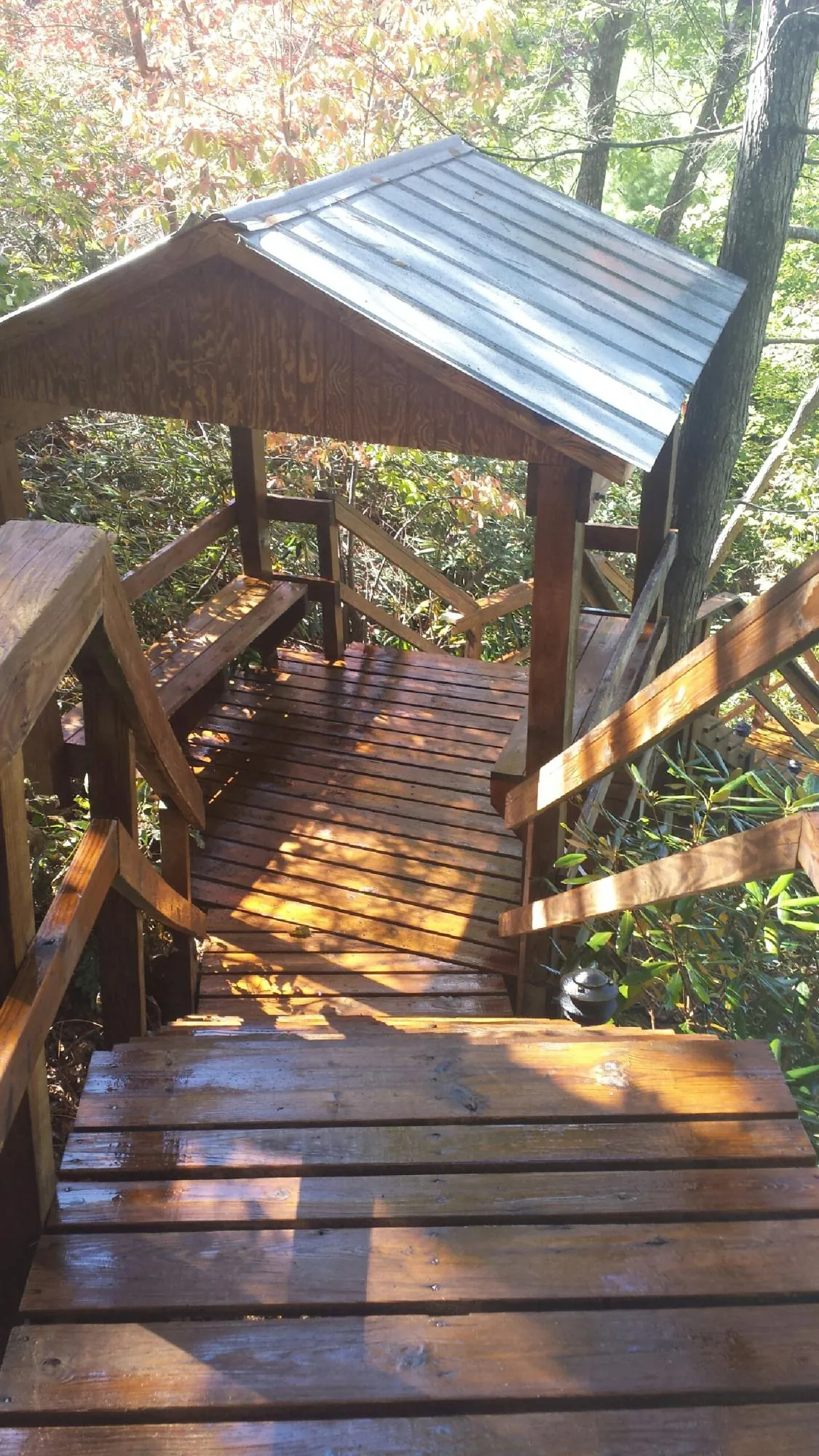 Freshly stained wood walkway and covered shelter with a metal roof in Wainscott